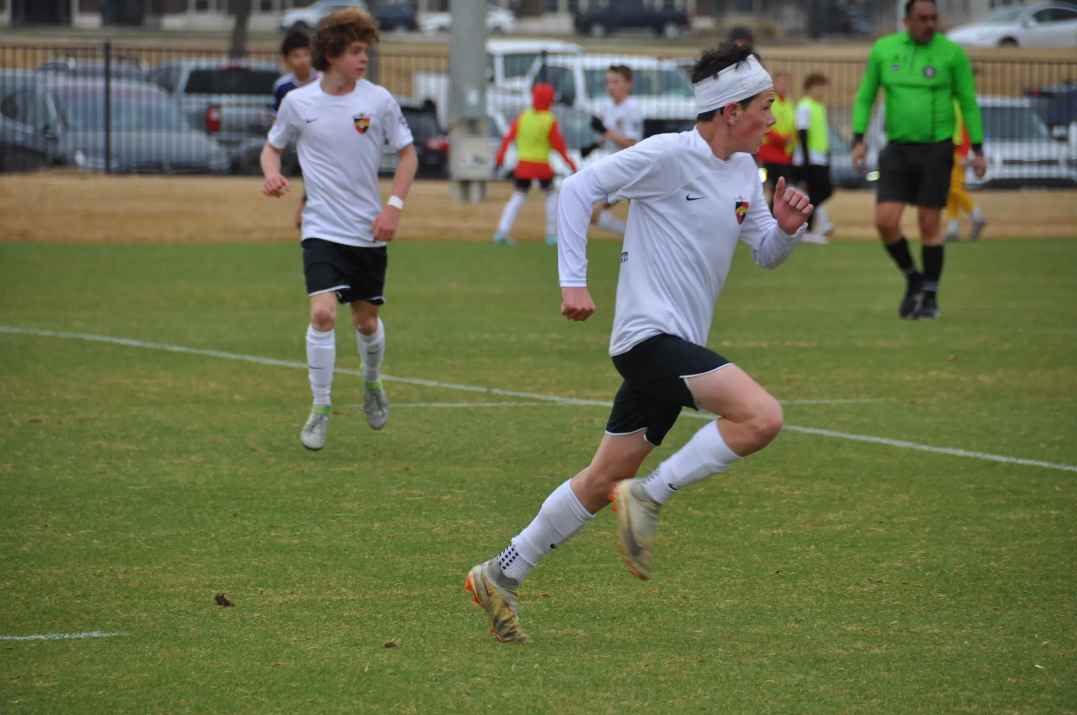 Daylen Hammon #17 in white Real Colorado soccer.com kit with white headband on the ball facing black-kitted defender during MLS League match March 2025
